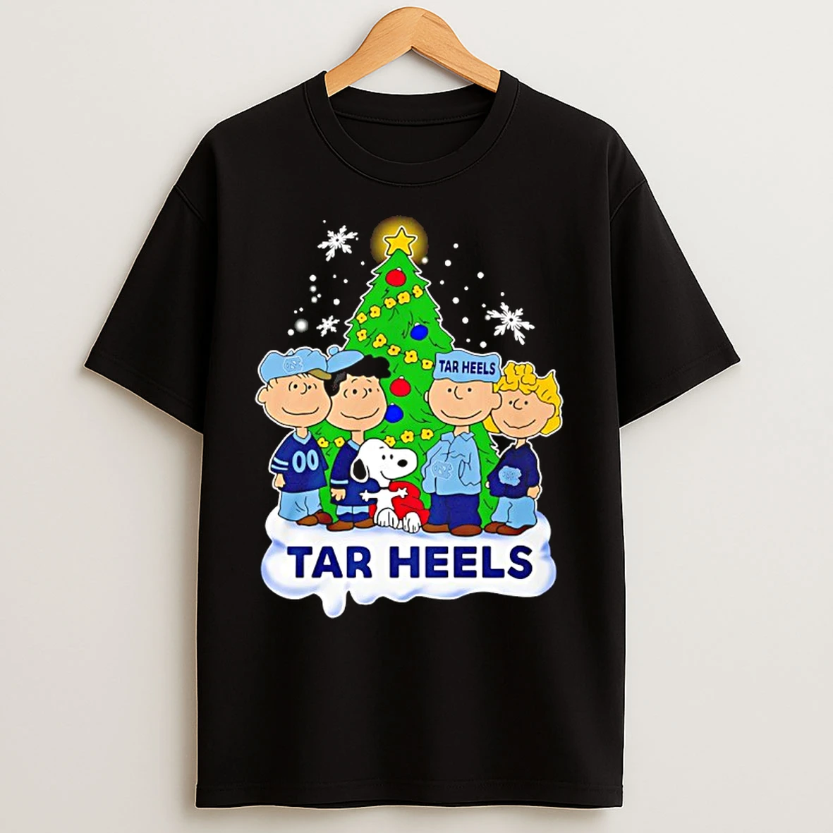 Classic North Carolina Tar Heels Snoopy And The Peanuts Christmas 2025 T Shirts