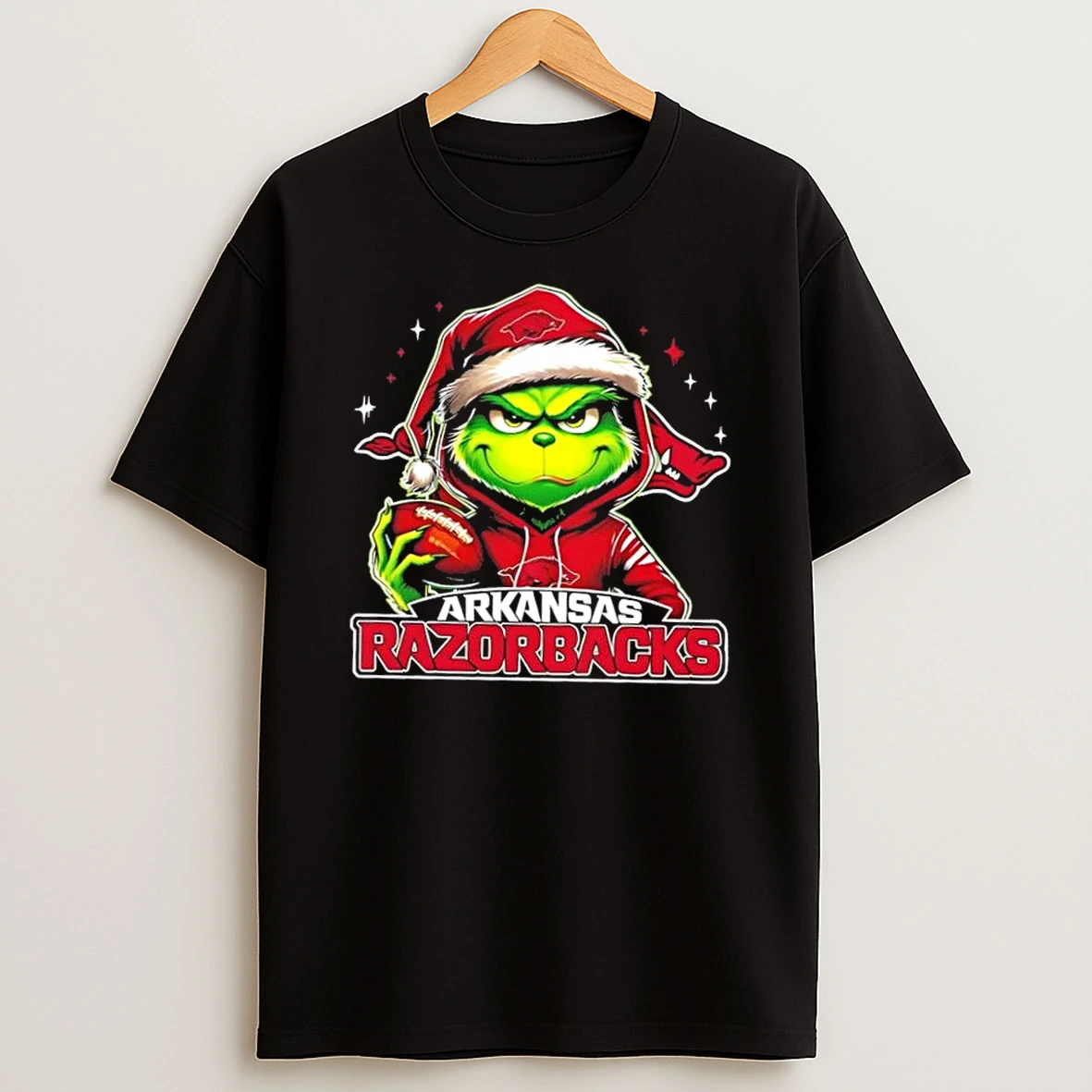 Grinch Is Holding A Ball And Smiling At Arkansas Razorbacks Fans Christmas Shirts