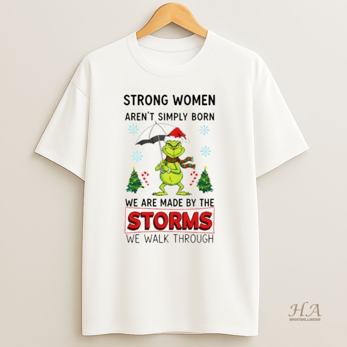 Official Grinch Santa Hat Strong Women Arent Simply Born We Are Made By The Storms We Walk Through Merry Christmas T Shirt 1